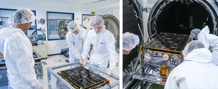 specialists-inspecting-satellite