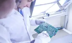 employees-inspecting-board